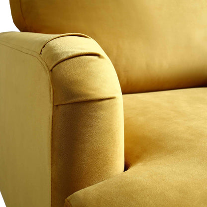 Fauteuil Brigette en velours moutarde avec pieds à roulettes en laiton antique