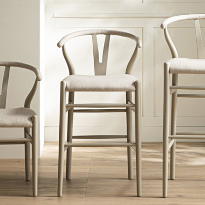 Tabouret de bar Hansel, structure taupe avec assise en tissu avoine